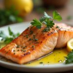 Baked salmon recipe garnished with parsley and lemon.